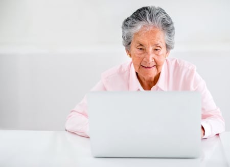 Elder woman using a laptop computer at home